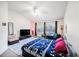 Bedroom with large windows, vaulted ceiling, a ceiling fan and home office space at 18981 Duquesne Dr, Tampa, FL 33647