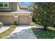 Close-up of townhome exteriors showcasing attached garages and landscaped walkways on a sunny day at 18981 Duquesne Dr, Tampa, FL 33647