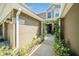 Inviting front entrance with a charming, landscaped pergola leading to the front door of the townhome at 18981 Duquesne Dr, Tampa, FL 33647