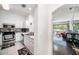 Well-lit kitchen with stainless steel appliances and white cabinetry, seamlessly connected to the living area at 18981 Duquesne Dr, Tampa, FL 33647