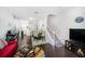 Open-concept living area with hardwood floors, dining space, and a staircase leading to upper level at 18981 Duquesne Dr, Tampa, FL 33647