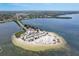 Breathtaking aerial view of a sandy beach peninsula with clear waters and lush greenery at 228 Shore Dr, Tarpon Springs, FL 34689