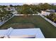Large, private fenced backyard with lush green grass and mature trees at 228 Shore Dr, Tarpon Springs, FL 34689