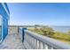 Balcony with views of the bay and landscaping, featuring a stucco railing and ocean themed decor at 228 Shore Dr, Tarpon Springs, FL 34689