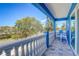 Balcony featuring blue Adirondack chairs, patterned tile, and scenic water views at 228 Shore Dr, Tarpon Springs, FL 34689