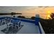 Scenic sunset view from a spacious balcony with outdoor seating, perfect for relaxation and entertainment at 228 Shore Dr, Tarpon Springs, FL 34689