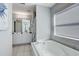 Spacious bathroom showcasing double sinks, a soaking tub, and clean tile flooring with a coastal design theme at 228 Shore Dr, Tarpon Springs, FL 34689