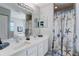 Bright bathroom featuring a double sink vanity with a quartz countertop and a decorative shower curtain at 228 Shore Dr, Tarpon Springs, FL 34689