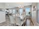 Dining room features a large table, modern chandelier, and views to the kitchen at 228 Shore Dr, Tarpon Springs, FL 34689