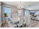 Bright dining room with a modern chandelier and elegant seating for eight at 228 Shore Dr, Tarpon Springs, FL 34689