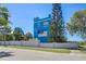 Unique blue home with eye-catching architecture, contrasted against a vibrant blue sky at 228 Shore Dr, Tarpon Springs, FL 34689