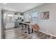 Modern kitchen with stainless steel appliances, bar stool seating, and stylish wood-look floors at 228 Shore Dr, Tarpon Springs, FL 34689