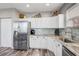 Updated kitchen featuring stainless steel appliances and white cabinetry at 228 Shore Dr, Tarpon Springs, FL 34689
