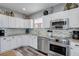 Well-equipped kitchen featuring stainless steel appliances and white cabinetry with ample storage at 228 Shore Dr, Tarpon Springs, FL 34689