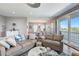 Open-plan living room with comfortable seating, natural light, and access to a balcony at 228 Shore Dr, Tarpon Springs, FL 34689