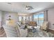 Open-concept living room with comfortable seating and access to the balcony at 228 Shore Dr, Tarpon Springs, FL 34689