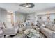 Comfortable living room featuring neutral tones, modern ceiling fan, and stylish furniture arrangement at 228 Shore Dr, Tarpon Springs, FL 34689