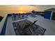 Expansive rooftop deck furnished with lounge chairs, dining sets, and ocean views at 228 Shore Dr, Tarpon Springs, FL 34689
