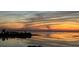 Colorful sunset reflected on the water, creating a vibrant and peaceful atmosphere at 228 Shore Dr, Tarpon Springs, FL 34689