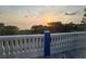 Scenic water view from balcony with beautiful sunset overlooking calm water and lush landscape at 228 Shore Dr, Tarpon Springs, FL 34689