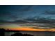 Beautiful sunset reflecting over calm waters with a distant shoreline, creating a picturesque view at 228 Shore Dr, Tarpon Springs, FL 34689