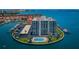 Stunning aerial view of waterfront condo featuring boat docks, pool, and expansive views of the bay and nearby city at 240 Sand Key Estates Dr # 58, Clearwater Beach, FL 33767