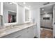 Modern bathroom with a double sink vanity with marble countertop and a glass door shower at 240 Sand Key Estates Dr # 58, Clearwater Beach, FL 33767