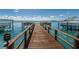 Wide shot of a long wooden dock on a sunny day at 240 Sand Key Estates Dr # 58, Clearwater Beach, FL 33767