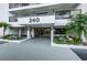 View of the entrance to the building with manicured landscaping at 240 Sand Key Estates Dr # 58, Clearwater Beach, FL 33767