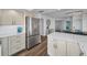 Modern kitchen featuring stainless steel appliances, white cabinets, and a white countertop island at 240 Sand Key Estates Dr # 58, Clearwater Beach, FL 33767