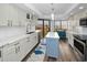 Modern kitchen featuring white cabinets, quartz countertops, and a blue kitchen island at 240 Sand Key Estates Dr # 58, Clearwater Beach, FL 33767