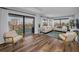 Bright living room with hardwood floors, city views, and access to a private balcony at 240 Sand Key Estates Dr # 58, Clearwater Beach, FL 33767