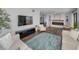 Inviting living room features a cozy fireplace, modern decor, and plenty of natural light at 240 Sand Key Estates Dr # 58, Clearwater Beach, FL 33767