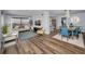 Bright living room featuring wood floors, stylish furniture, and large windows showcasing water views at 240 Sand Key Estates Dr # 58, Clearwater Beach, FL 33767
