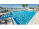 Sparkling blue swimming pool with a jacuzzi, surrounded by a patio and landscaping at 240 Sand Key Estates Dr # 58, Clearwater Beach, FL 33767