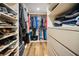 Organized walk-in closet with shelving, hanging clothes and lots of storage at 240 Sand Key Estates Dr # 58, Clearwater Beach, FL 33767