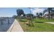 Scenic waterfront community area featuring lush lawn with tropical landscaping and a wooden swing at 2424 W Tampa Bay Blvd # A106, Tampa, FL 33607