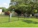 Fenced dog park area with mature trees and green space at 2424 W Tampa Bay Blvd # A106, Tampa, FL 33607
