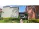 Exterior view of the building featuring well-maintained greenery and brick pathway at 2424 W Tampa Bay Blvd # A106, Tampa, FL 33607