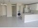Open-concept kitchen featuring white cabinetry, modern appliances, in-unit laundry, and tile floors at 2424 W Tampa Bay Blvd # A106, Tampa, FL 33607