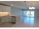 Open-concept kitchen with a breakfast bar, updated appliances, and large sliding glass door at 2424 W Tampa Bay Blvd # A106, Tampa, FL 33607