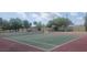 Well-maintained tennis court with mature landscaping and lighting for evening play at 2424 W Tampa Bay Blvd # A106, Tampa, FL 33607