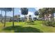 Grassy area with a view of waterfront condos and palm trees at 2424 W Tampa Bay Blvd # A106, Tampa, FL 33607