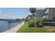 Picturesque waterfront walking path next to a condominium with boat docks and lush greenery at 2424 W Tampa Bay Blvd # A106, Tampa, FL 33607