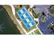 Aerial view of the Waterford pickleball courts next to clubhouse and parking at 25317 E Lenox Cir, Punta Gorda, FL 33950