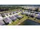 Aerial perspective of residence, pond and fountain with neighboring residences at 25317 E Lenox Cir, Punta Gorda, FL 33950