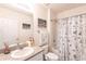 Neutral toned bathroom with vanity, tub with shower, and seashell accents at 25317 E Lenox Cir, Punta Gorda, FL 33950