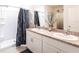 Bathroom with double sink vanity, granite countertop and walk-in shower with blue patterned curtain at 25317 E Lenox Cir, Punta Gorda, FL 33950