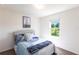 Bright bedroom with a comfortable bed, an interesting print and a sun-lit window at 25317 E Lenox Cir, Punta Gorda, FL 33950