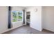 Carpeted bedroom featuring a window with tree views and a closet at 25317 E Lenox Cir, Punta Gorda, FL 33950